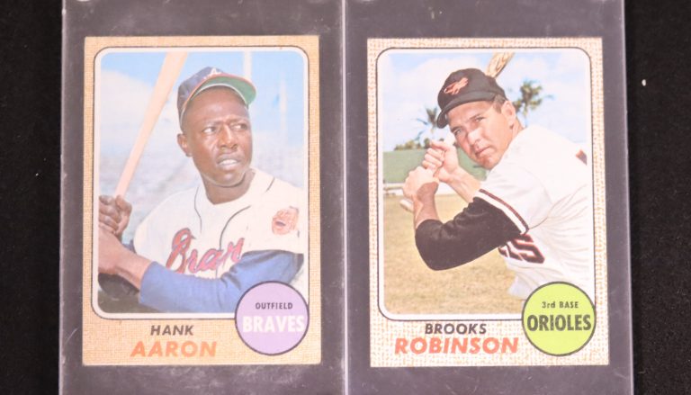 Old baseball cards of Hank Aaron and Brooks Robinson