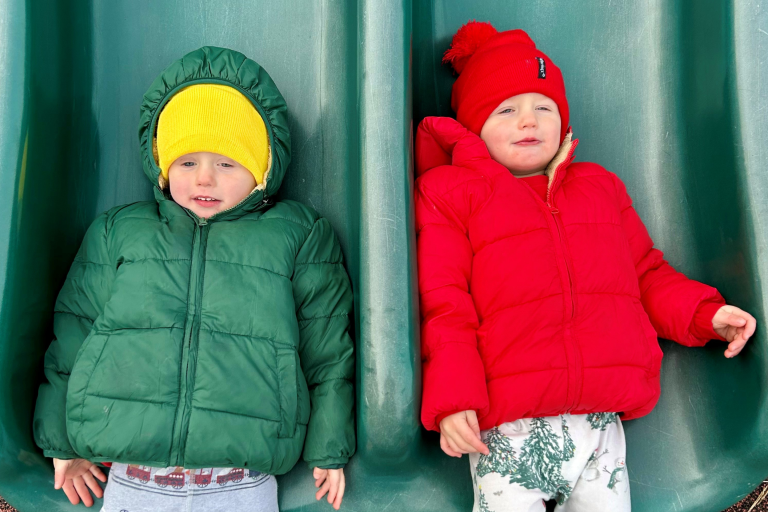 Twins on a slide during the Christmas season