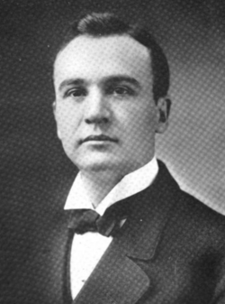 man in a tuxedo looking at the camera